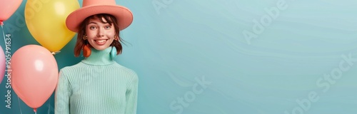 Young Woman in Turquoise Sweater Posing With Colorful Balloons Against Blue B...