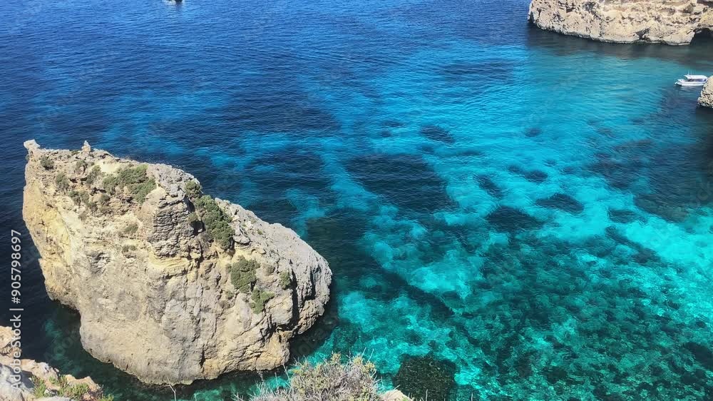 Beautiful Comino sea caves and Natural arches. Boat in the crystal clear mediterranean sea. Seen from the cliffs near Santa Marija tower. High quality 4k footage Beautiful Comino sea caves and Natural arches. Boat in the crystal clear mediterranean sea. Seen from the cliffs near Santa Marija tower. High quality 4k footage