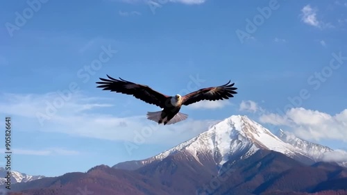 An eagle soars majestically over mountainous terrain, showcasing the beauty of nature and freedom in a cinematic style.