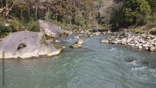 日本の風景 緑色の渓流と、苔のむした立派な岩をドローンで空撮 宮崎県の観光地