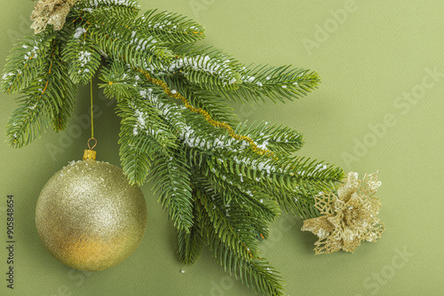 Traditional New Year composition. Festive decor, snowy Christmas tree branches, balls, flowers photo