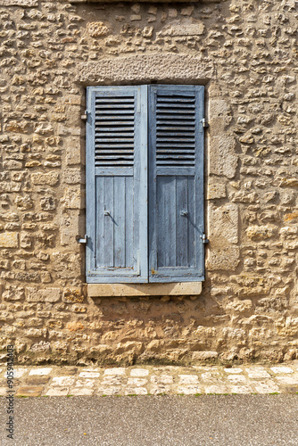 Rustic Blue Shutters on Stone Wall