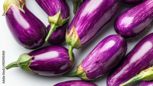 Close-up of two fresh, vibrant purple eggplants on a white background, ideal for culinary and agricultural themes.