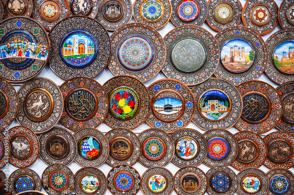 traditional Uzbek wooden handmade gift plates with wood carvings hand-painted in the souvenir shop of Uzbekistan in Tashkent traditional Uzbek wooden handmade gift plates with wood carvings hand-painted in the souvenir shop of Uzbekistan in Tashkent