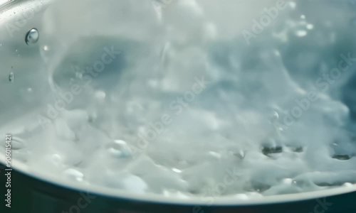 Macro Close up of evaporating and bubbles boiling water  photo