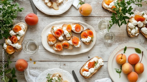 White wooden table adorned with ricotta bruschettas, pears, and apricots, creating a delightful and fresh culinary scene photo