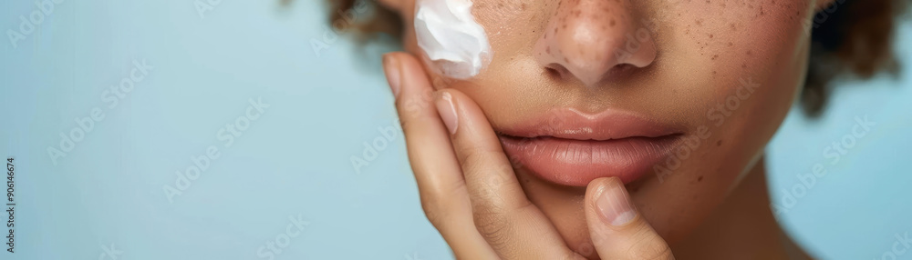Closeup of a young woman gently applying moisturizer to her face, with a serene expression and glowing skin Closeup of a young woman gently applying moisturizer to her face, with a serene expression and glowing skin