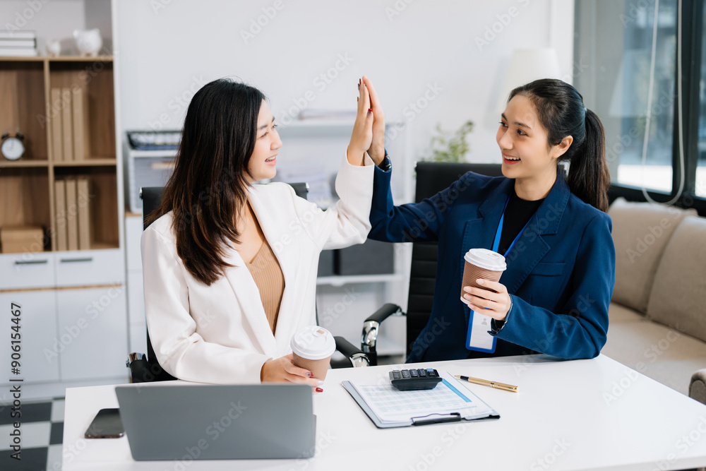 Two business workers talking on the smartphone and using laptop at office. Two business workers talking on the smartphone and using laptop at office.