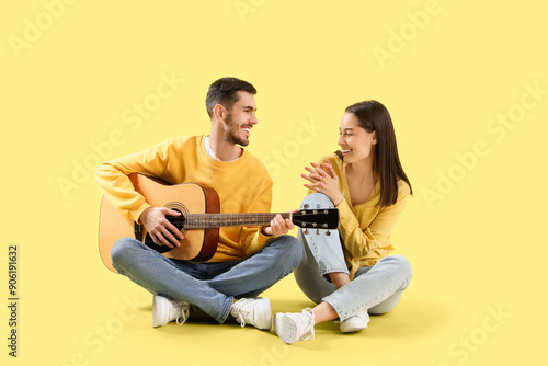Happy young couple with gui...