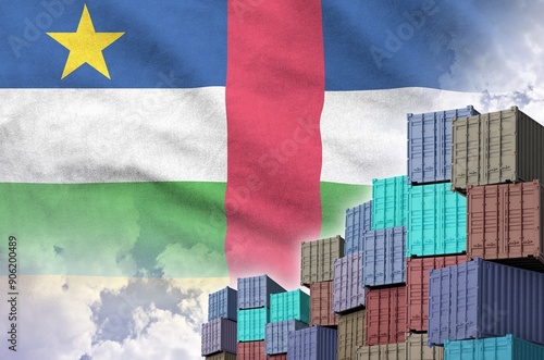 Central African Republic flag and big stack of shipping cargo containers in docks with sky background close up photo