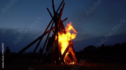 Beautiful bonfire on meadow on August 1st national holiday of Switzerland at Swiss City of Zürich on a summer night. Movie shot August 1st, 2024, Zurich, Switzerland.
