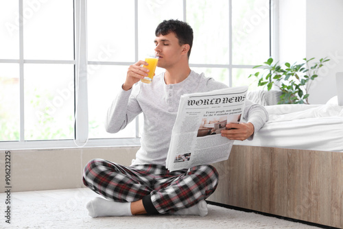 Young man with newspaper dr...