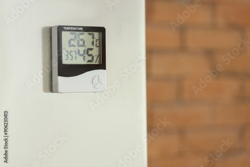 Digital hygrometer on wall in kitchen, closeup