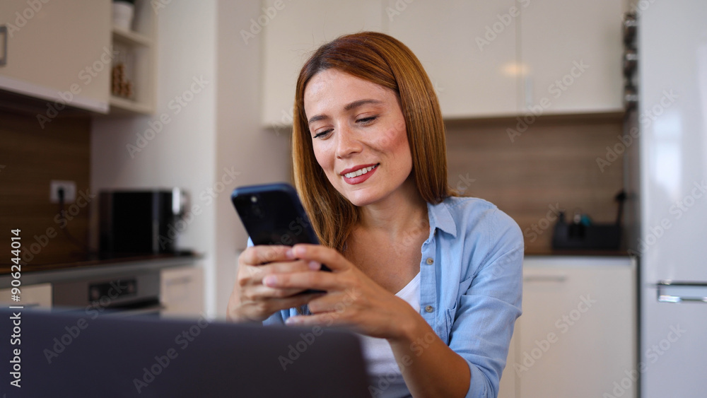 Happy woman shopping online on her laptop and smartphone Happy woman shopping online on her laptop and smartphone
