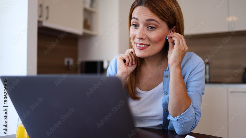 Beautiful woman working online at home and making a video call on her laptop Beautiful woman working online at home and making a video call on her laptop