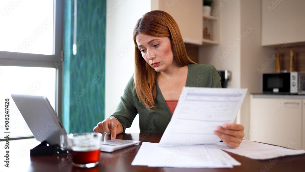 Worried woman using a digital tablet and trying to manage her finances at home Worried woman using a digital tablet and trying to manage her finances at home