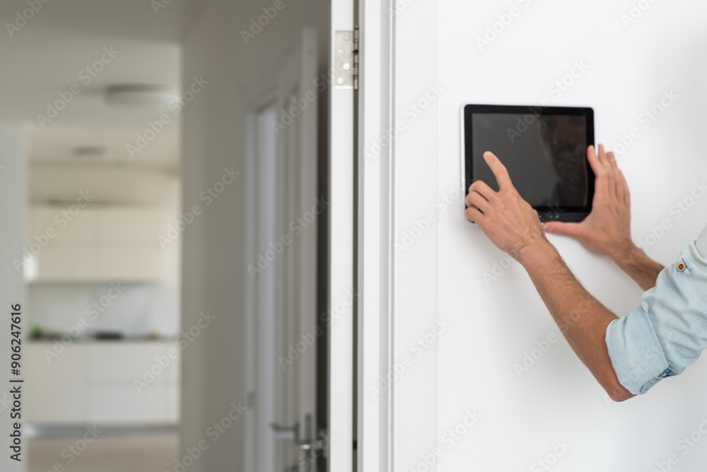 automation, internet of things and technology concept - man looking at tablet pc computer at smart home automation, internet of things and technology concept - man looking at tablet pc computer at smart home