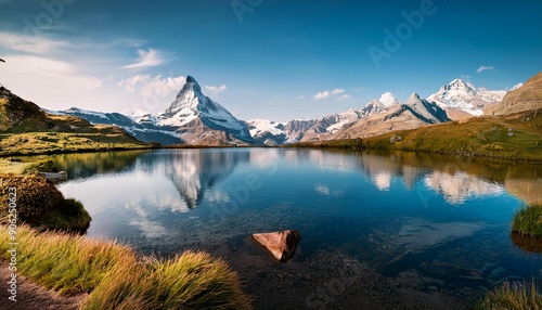 Amazing tourquise Oeschinnensee with waterfalls, wooden chalet and Swiss Alps, Berner Oberla  photo