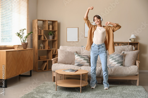Happy young woman in headph...
