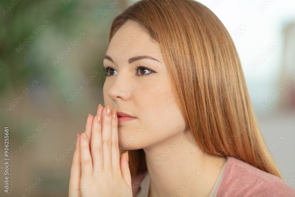 portrait of good-looking young european female holding hands in pray portrait of good-looking young european female holding hands in pray