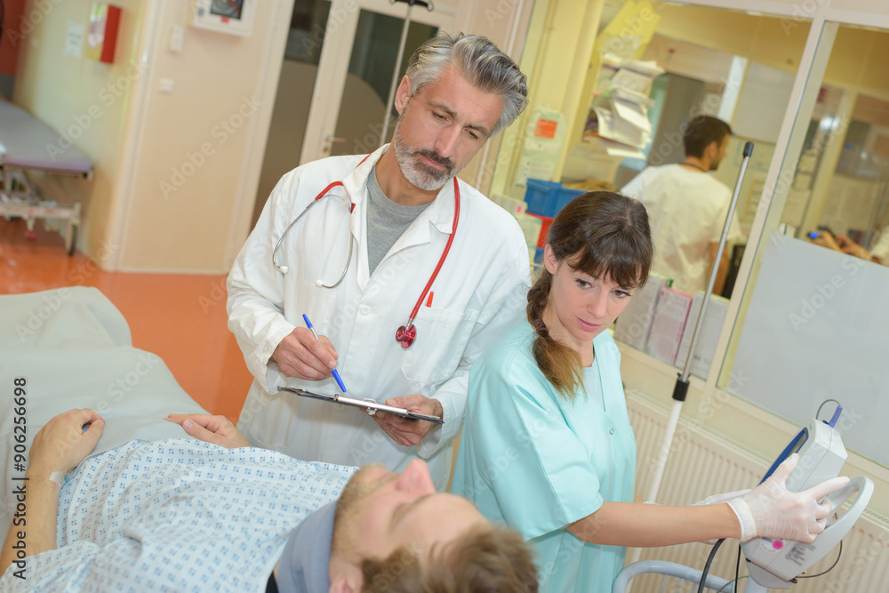 Fototapeta premium doctor with clipboard questioning patient