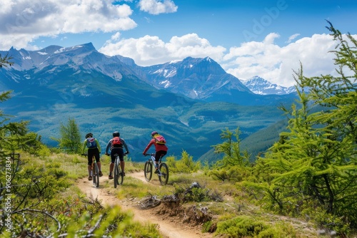 A group of three mountain bikers ride excitedly on a mountain.