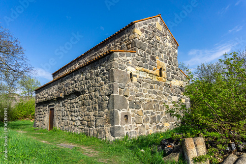 Side view of the medieval basilica. Orange tiled roof, stone walls. Samshvilde photo