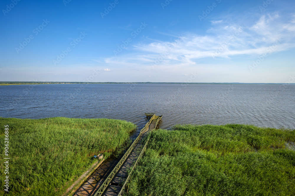 View from the observation tower towards the lake. The pier and rushes in the foreground. Lake Lebsko, Slowinski National Park, Leba, Poland
