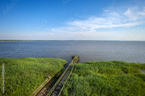 Obraz na płótnie View from the observation tower towards the lake. The pier and rushes in the foreground. Lake Lebsko, Slowinski National Park, Leba, Poland w salonie