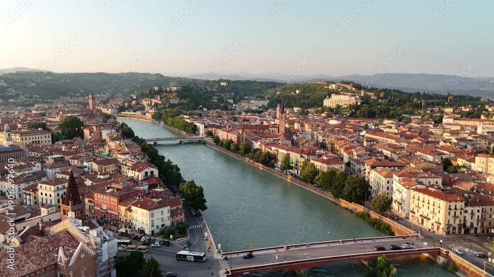 Panoramic drone view over Verona, Italy. Aerial 4k footage of river Adige, Ponte Nuovo and Ponte Navi. Cityscape at sunset. Wonderful aerial shot of the city of Romeo and Juliet. Tourism and romance. Panoramic drone view over Verona, Italy. Aerial 4k footage of river Adige, Ponte Nuovo and Ponte Navi. Cityscape at sunset. Wonderful aerial shot of the city of Romeo and Juliet. Tourism and romance.
