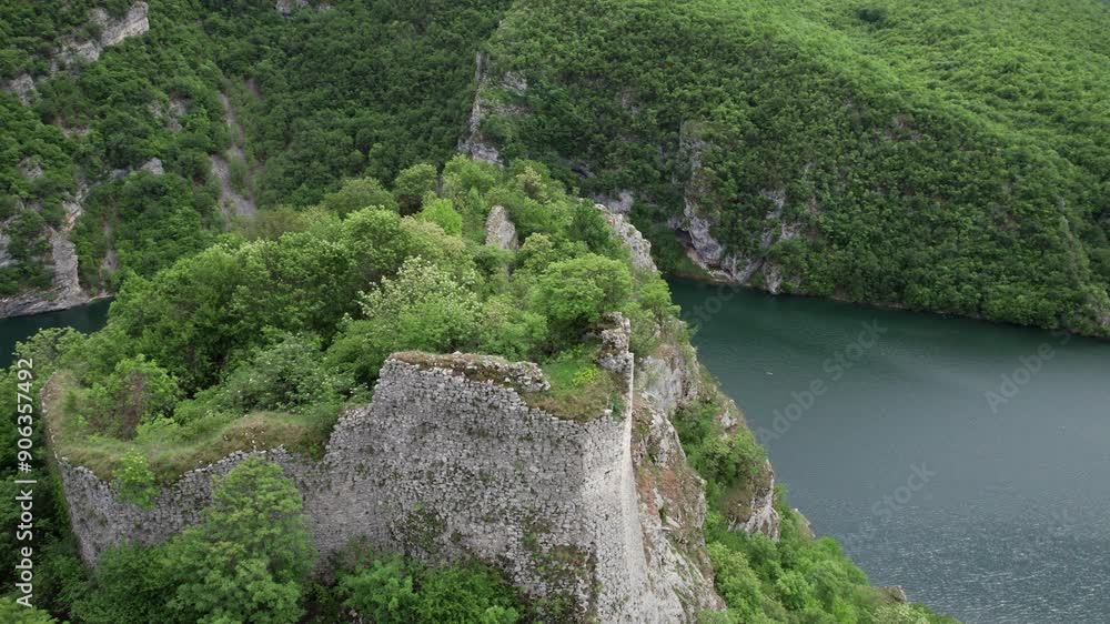 Aerial view of old castle on top of a hill with hydroelectric power plant Aerial view of old castle on top of a hill with hydroelectric power plant