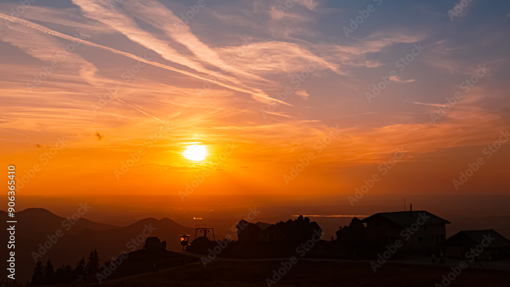 Obraz premium Alpine sunset or sundowner with the silhouette of Steinlingalm at Mount Kampenwand, Aschau, Chiemgau, Rosenheim, Bavaria, Germany