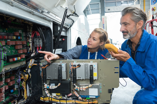 male and female bus mechanics