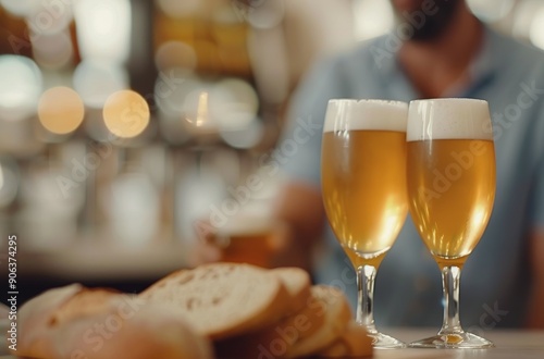Two Glasses of Beer With Fresh Bread on a Rustic Table in a Warm Bar Setting