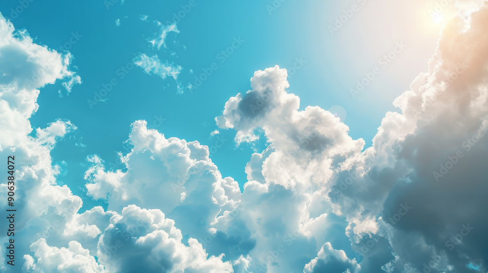 Fluffy white clouds float across a bright blue sky, with the sun partially visible, illuminating a peaceful and serene daytime scene. Fluffy white clouds float across a bright blue sky, with the sun partially visible, illuminating a peaceful and serene daytime scene.
