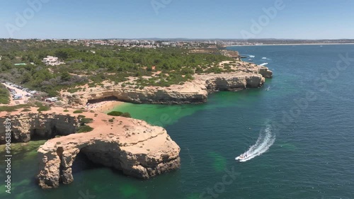 Portugal coastline, white sand beaches, turquoise water and rocky cliffs in Algarve province, Southern Portugal. Aerial drone footage of the Benagil beach