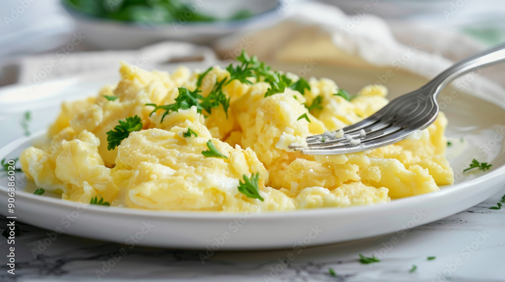 Smooth, creamy egg mashed with a fork and served on a white plate. Smooth, creamy egg mashed with a fork and served on a white plate.