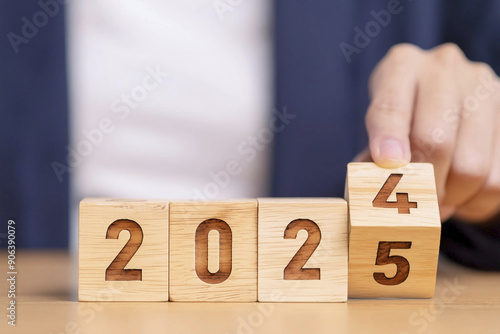 2025. Happy New Year 2025. Sparkling New Year. 2025 balloons. Wooden block with change from 2024 to 2025. Heading to a new year. Background design and congratulations. Design with fireworks. Space.