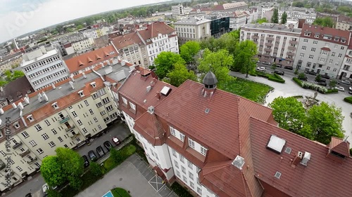 This captivating aerial footage presents a comprehensive perspective of a bustling cityscape, where historical structures coexist harmoniously with modern developments. The video commences with a photo