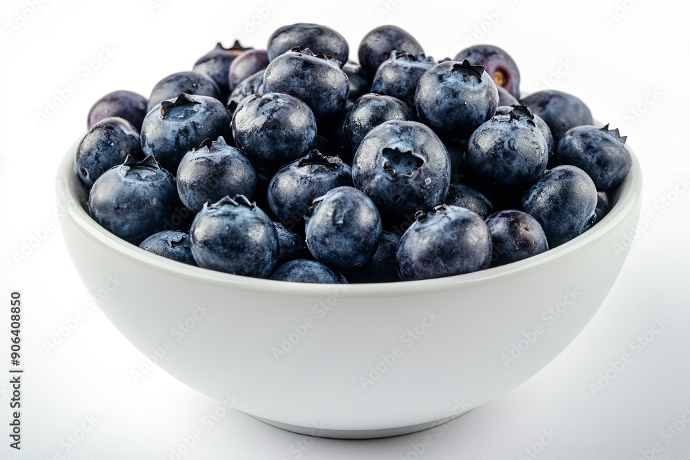 Fresh blueberries arranged neatly in a white bowl on a plain background Fresh blueberries arranged neatly in a white bowl on a plain background
