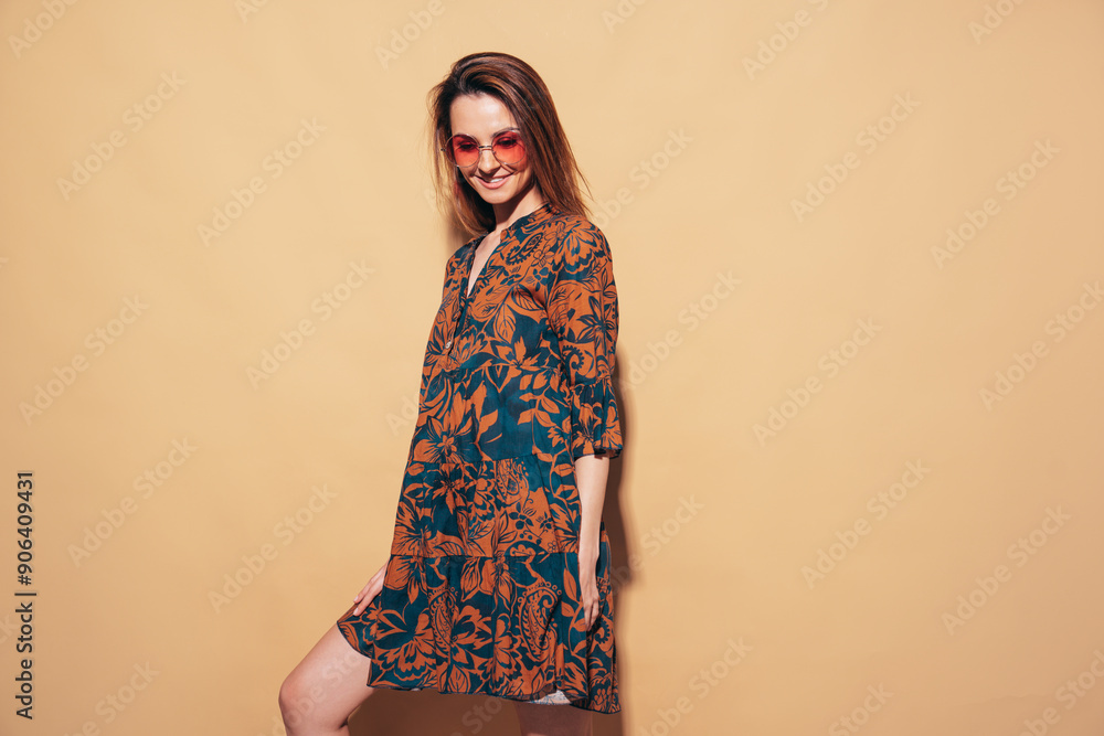 Young beautiful smiling female in trendy summer dress. Sexy carefree woman posing in studio on beige background. Positive brunette model having fun. Cheerful and happy. Isolated Young beautiful smiling female in trendy summer dress. Sexy carefree woman posing in studio on beige background. Positive brunette model having fun. Cheerful and happy. Isolated