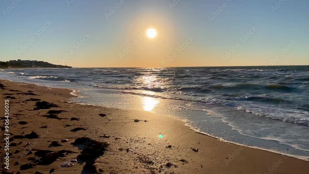 Close-up of a golden sandy shore against the backdrop of calm sunset sea waves. High quality 4k footage Close-up of a golden sandy shore against the backdrop of calm sunset sea waves. High quality 4k footage