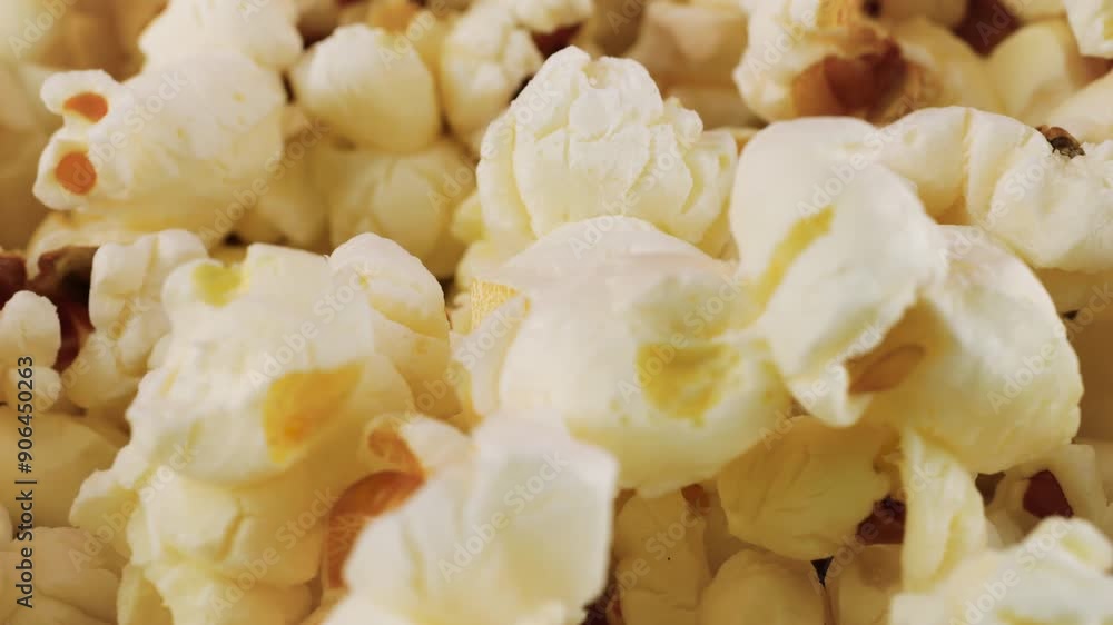 Rotating popcorn grains. Popcorn background. Macro and close-up. Rotating popcorn grains. Popcorn background. Macro and close-up.