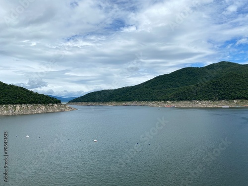 Wallpaper Mural Scenic view of a dam in the mountains with a river, lush green trees, and a clear blue sky at Bhumiphol Dam, Tak, Thailand. Torontodigital.ca