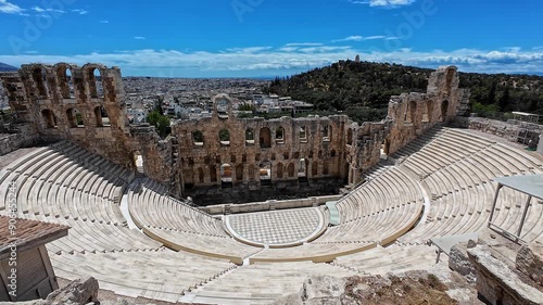 Profile view of Odeon of Herodes Atticus on a sunny day at the Acropolis of Athens, Greece. photo