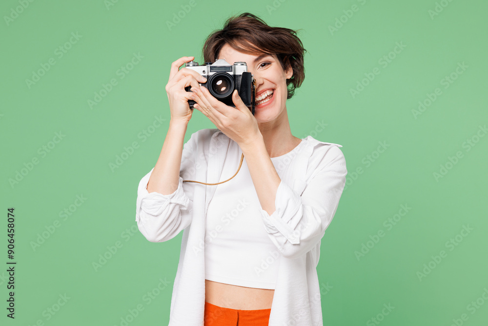 Traveler happy smiling cool woman wears casual clothes photo camera taking picture isolated on plain green background. Tourist travel abroad in free spare time rest getaway. Air flight trip concept. Traveler happy smiling cool woman wears casual clothes photo camera taking picture isolated on plain green background. Tourist travel abroad in free spare time rest getaway. Air flight trip concept.
