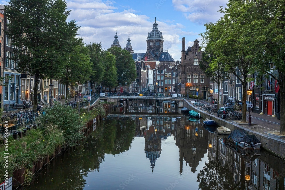 Image of St Nicholas Basilica in Amsterdam with adjacent canal in summer 2023 Image of St Nicholas Basilica in Amsterdam with adjacent canal in summer 2023