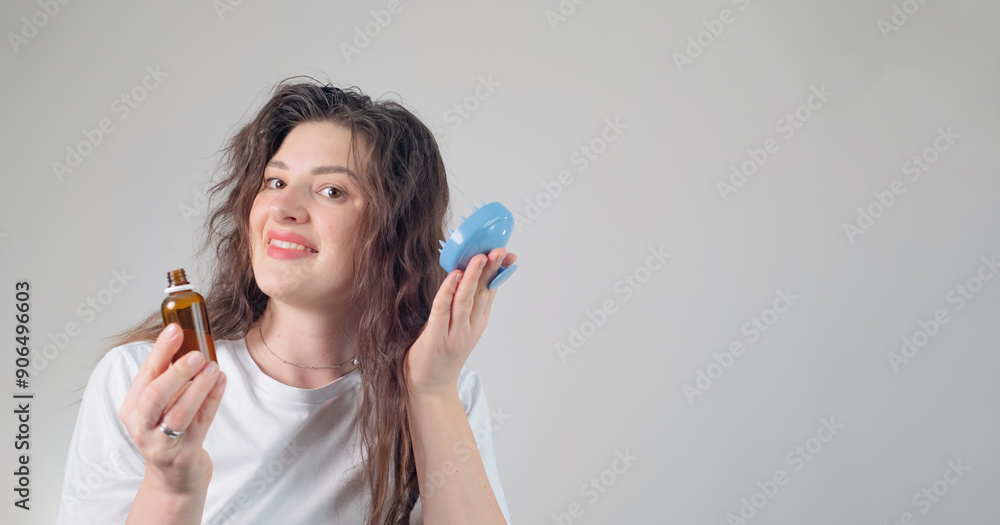 Brunette with curly hair holds hair care product, showcasing routine for maintaining healthy and defined curls. Brunette with curly hair holds hair care product, showcasing routine for maintaining healthy and defined curls.