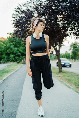 Young caucasian woman is stretching and preparing for run or jogging