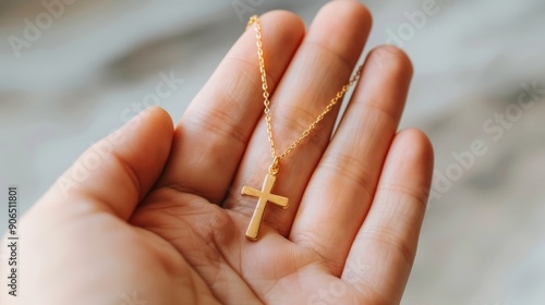 Wallpaper Mural Close-Up of Hand Holding Cross Necklace Against Plain Background Torontodigital.ca